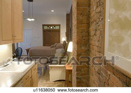 Brick wall in small studio apartment View Large Photo Image Stock Image - Brick wall in small studio apartment. Fotosearch