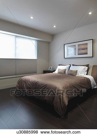 Brown bed in minimalistic bedroom View Large Photo Image Stock Photo - Brown bed in minimalistic bedroom. Fotosearch