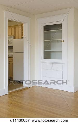 Stock Photo - Built in drawers and cabinet in empty apartment. Fotosearch
