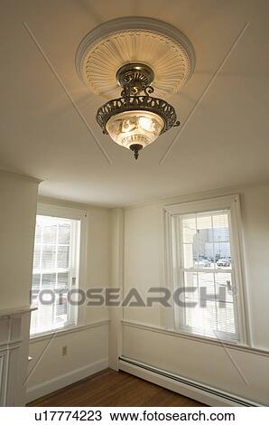 Stock Image - Ceiling light in empty room. Fotosearch
