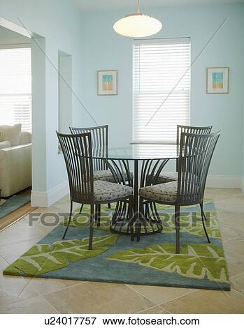 Circular glass table on blue and green area rug View Large Photo Image Stock Photo - Circular glass table on blue and green area rug. Fotosearch