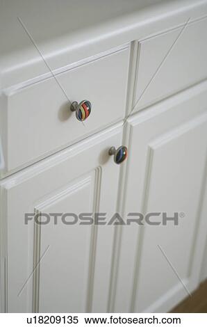 Stock Photography - Colorful knobs on kitchen cabinet. Fotosearch