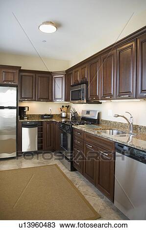Contemporary kitchen with dark colored cabinets View Large Photo Image Stock Image - Contemporary kitchen with dark colored cabinets. Fotosearch