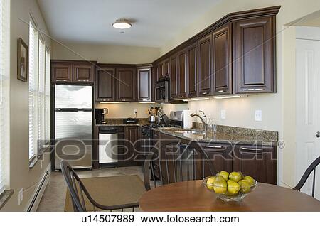 Contemporary kitchen with dark colored cabinets View Large Photo Image Stock Photo - Contemporary kitchen with dark colored cabinets. Fotosearch
