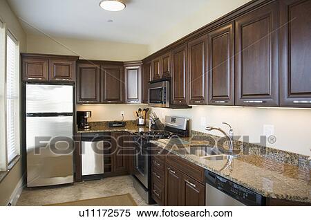 Stock Photography - Contemporary kitchen with dark colored cabinets. Fotosearch