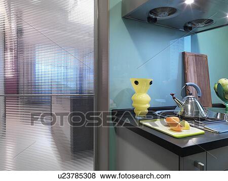 Stock Photo - Countertop and stove in modern blue kitchen. Fotosearch