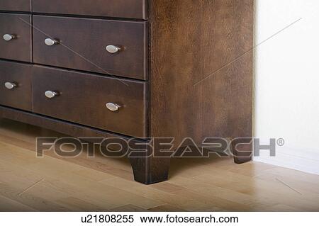Detail brown wooden dresser on hardwood floor View Large Photo Image Stock Photography - Detail brown wooden dresser on hardwood floor. Fotosearch