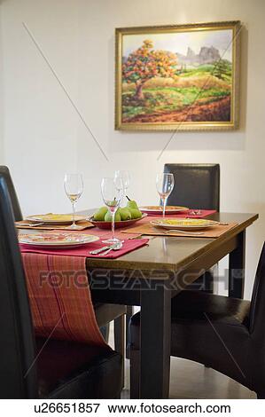 Stock Photo - Detail colorful place settings on dining room table. Fotosearch