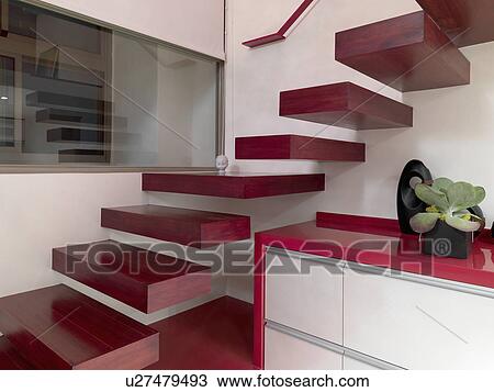 Stock Image - Detail red floating staircase. Fotosearch