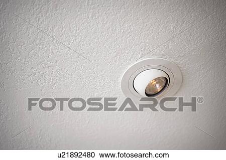 Stock Image - Detail textured ceiling with recessed light. Fotosearch