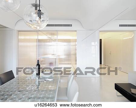 Stock Image - Dining table in white modern interior. Fotosearch