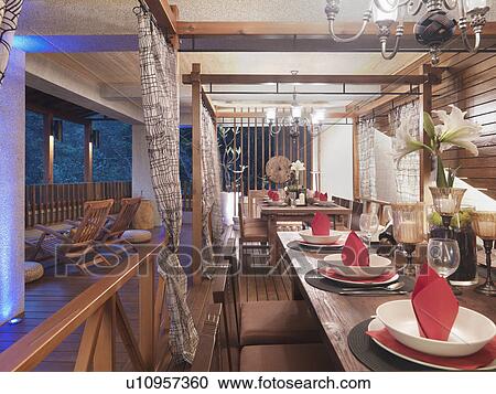 Dining table with chandeliers set up on deck View Large Photo Image Stock Image - Dining table with chandeliers set up on deck. Fotosearch