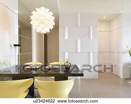 Stock Image - Dining table with yellow chairs. Fotosearch