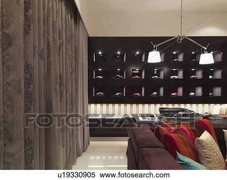 Stock Photography - Drapes and toy car collection in modern living room. Fotosearch