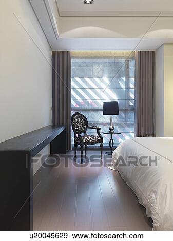 Stock Photo - Elegant chair and hardwood floor in bedroom. Fotosearch