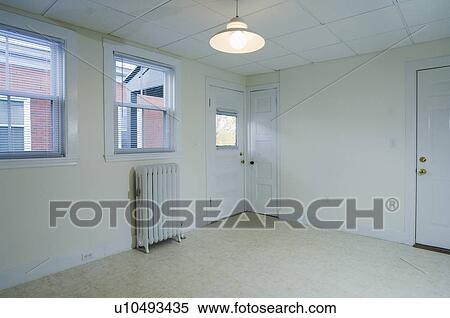Stock Photography - Empty apartment with tile floor and a heater. Fotosearch