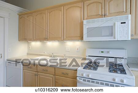 Empty Kitchen With Light Colored Cabinets Stock Photo U10316209 Fotosearch