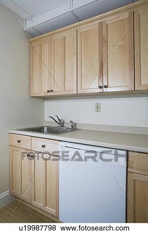 Empty kitchen with light colored cabinets View Large Photo Image Stock Photo - Empty kitchen with light colored cabinets. Fotosearch