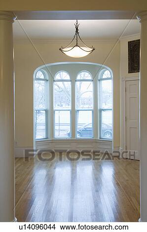 Empty room in apartment with hardwood floor and bay window View Large Photo Image Picture - Empty room in apartment with hardwood floor and bay window. Fotosearch