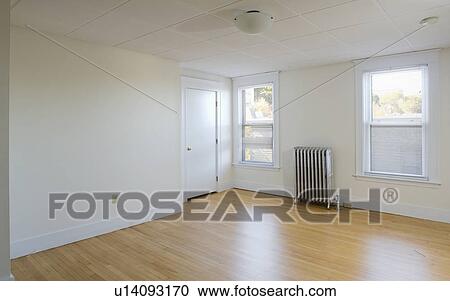 Empty room in apartment with hardwood floor and heater View Large Photo Image Stock Image - Empty room in apartment with hardwood floor and heater. Fotosearch