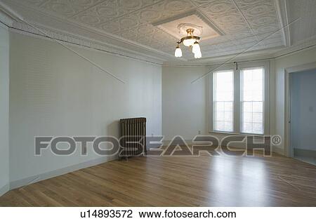 Empty room in apartment with hardwood floor and heater View Large Photo Image Stock Image - Empty room in apartment with hardwood floor and heater. Fotosearch