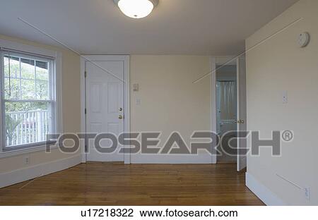 Stock Image - Empty room in apartment with hardwood floor. Fotosearch