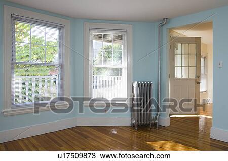 Empty room in apartment with hardwood floor and heater View Large Photo Image Stock Image - Empty room in apartment with hardwood floor and heater. Fotosearch