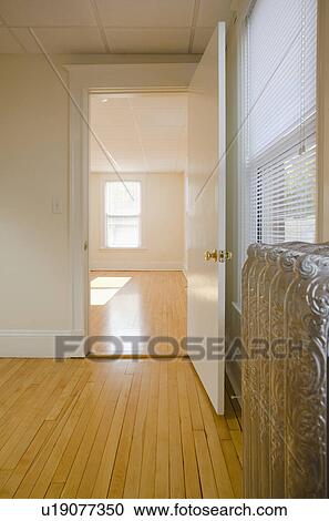Empty room in apartment with hardwood floor and heater View Large Photo Image Stock Image - Empty room in apartment with hardwood floor and heater. Fotosearch