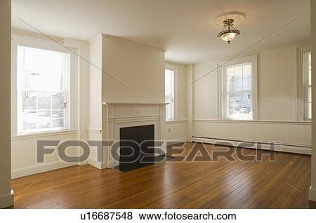 Empty room in apartment with hardwood floor and fireplace View Large Photo Image Stock Photo - Empty room in apartment with hardwood floor and fireplace. Fotosearch