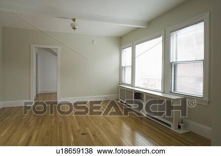 Empty room in apartment with hardwood floor View Large Photo Image Stock Photo - Empty room in apartment with hardwood floor. Fotosearch