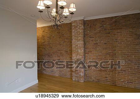 Empty room in apartment with hardwood floor and brick wall View Large Photo Image Stock Photo - Empty room in apartment with hardwood floor and brick wall. Fotosearch