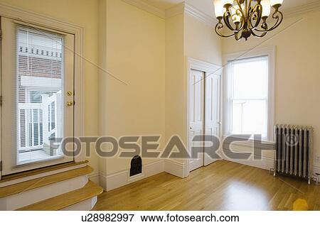 Stock Photo - Empty room in apartment with hardwood floor and heater. Fotosearch