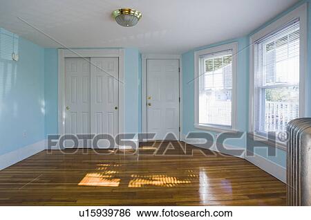 Empty room in apartment with hardwood floor and heater View Large Photo Image Stock Photograph - Empty room in apartment with hardwood floor and heater. Fotosearch