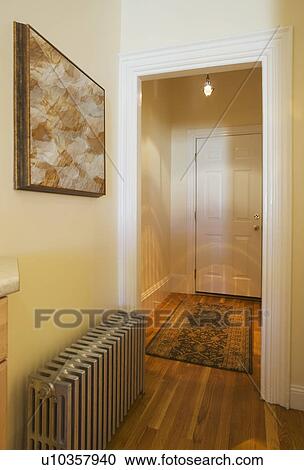 Stock Image - Entrance hall and heater in studio apartment. Fotosearch