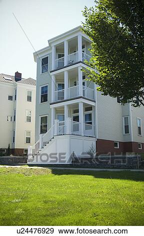 Stock Photo - Exterior view multi level apartment building with porches. Fotosearch