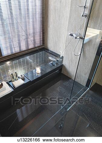 Stock Photograph - Glass shower and tile bathtub. Fotosearch