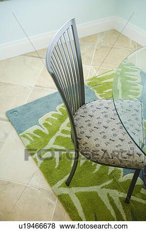 Glass table and chair on blue and green area rug View Large Photo Image Stock Photo - Glass table and chair on blue and green area rug. Fotosearch