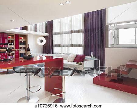 Stock Photograph - Kitchen and living room in modern apartment home. Fotosearch
