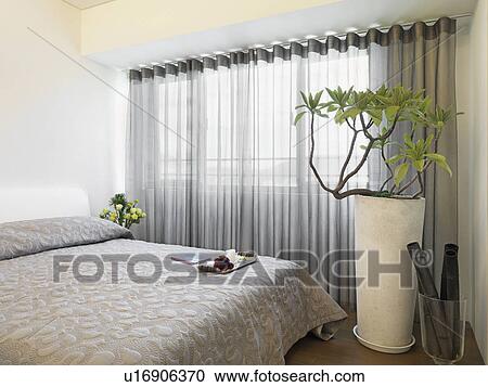 Stock Image - Large bed in bedroom. Fotosearch