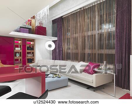Stock Image - Large white leather sofa in modern interior. Fotosearch