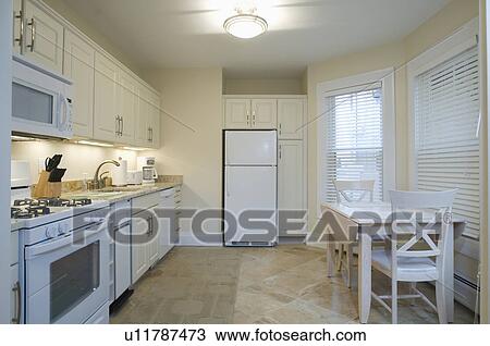 Stock Image - Light colored traditional kitchen. Fotosearch