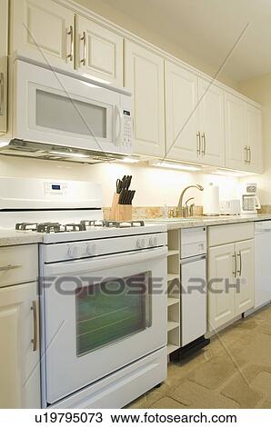 Stock Image - Light colored traditional kitchen. Fotosearch