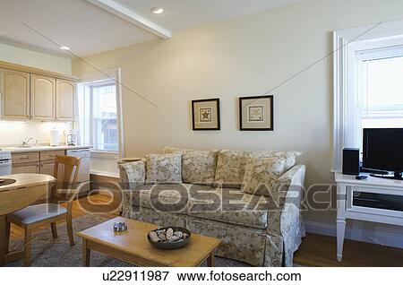 Stock Photo - Living area and kitchen in small studio apartment. Fotosearch