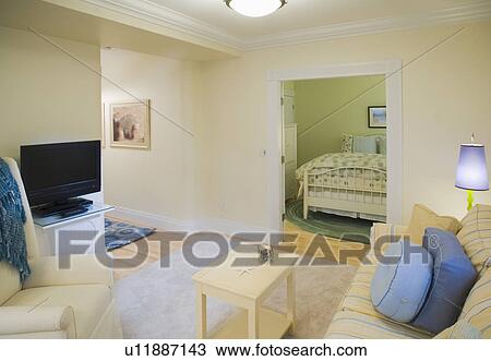 Stock Image - Living room outside of bedroom in apartment home. Fotosearch