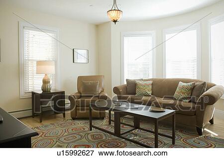 Stock Photo - Living room with colorful area rug. Fotosearch
