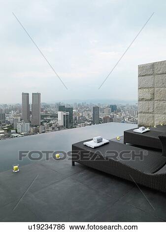 Lounge chairs on patio overlooking city View Large Photo Image Stock Photograph - Lounge chairs on patio overlooking city. Fotosearch