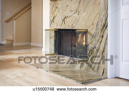 Stock Photo - Marble fireplace with glass doors. Fotosearch