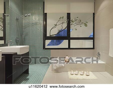 Stock Image - Modern bathroom with mosaic tile shower. Fotosearch
