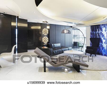 Stock Photo - Modern chaise lounge in living room. Fotosearch