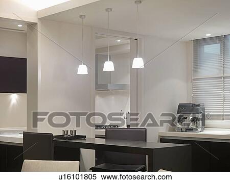 Stock Photography - Modern dining table and pendant lights. Fotosearch